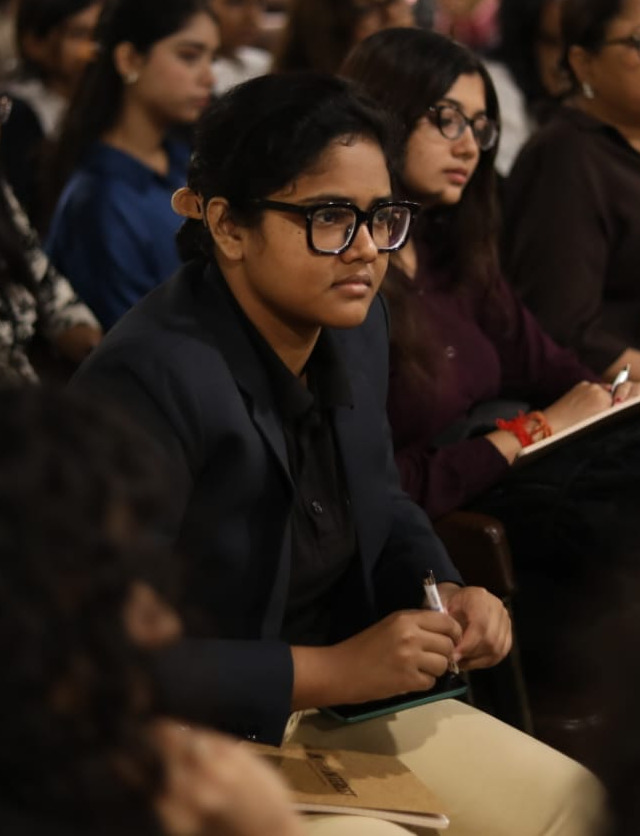 Syeda Tasnim Fatmi taking notes at an industry session